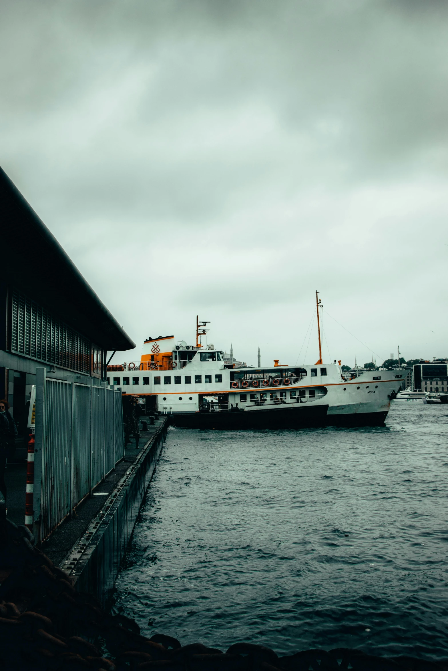 a boat that is sitting in the water, stockholm city, gloomy skies, thumbnail, high-quality photo