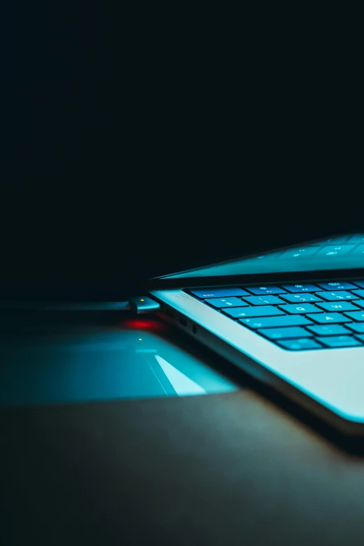 a laptop computer sitting on top of a table, pexels, computer art, blue and red lights, thumbnail, close up portrait shot, tech-noir