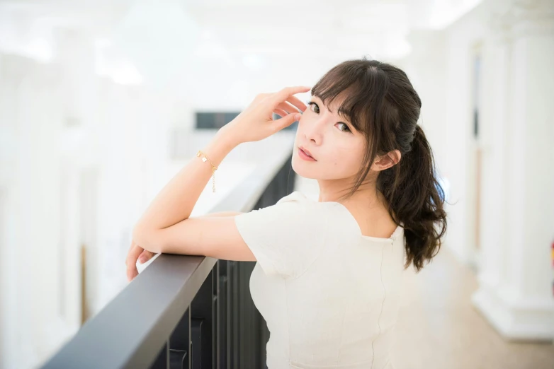 a woman in a white shirt leaning on a railing, by Sengai, unsplash, shin hanga, in a white room, with cute - fine - face, ayaka cosplay, 奈良美智