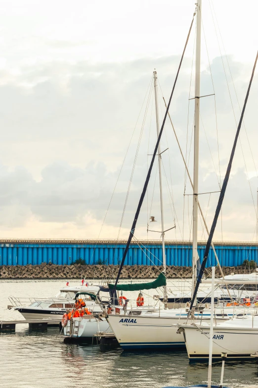 a number of boats in a body of water, jerez, relaxing on a yacht at sea, standing on the mast, near a jetty