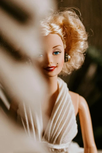 a close up of a doll wearing a dress, inspired by Harrison Fisher, trending on unsplash, face like marilyn monroe, bali, toys, lovingly looking at camera