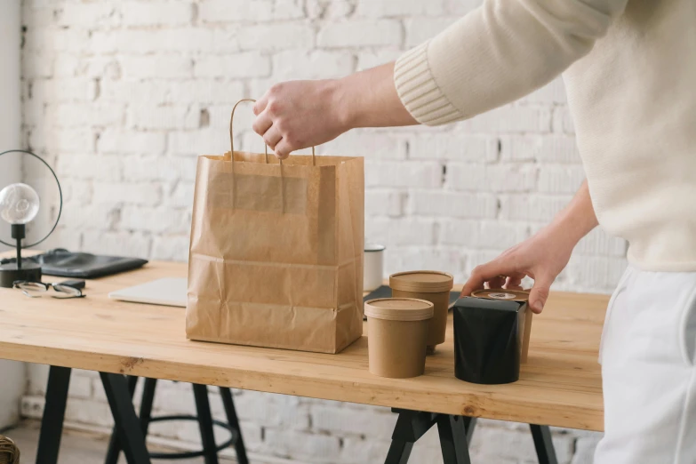 a person putting a paper bag on top of a table, coffee cups, detailed product image, fan favorite, full product shot