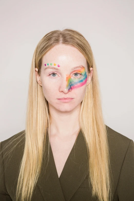 a woman with colorful paint on her face, an album cover, inspired by Okuda Gensō, trending on pexels, renaissance, britt marling style 3/4, half human half alien, sophie turner, stripe over eye
