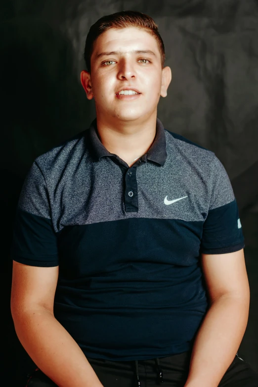 a man with a tennis racket poses for a picture, an album cover, inspired by Eddie Mendoza, pexels contest winner, wearing a dark blue polo shirt, portrait of 14 years old boy, 15081959 21121991 01012000 4k, eloy morales