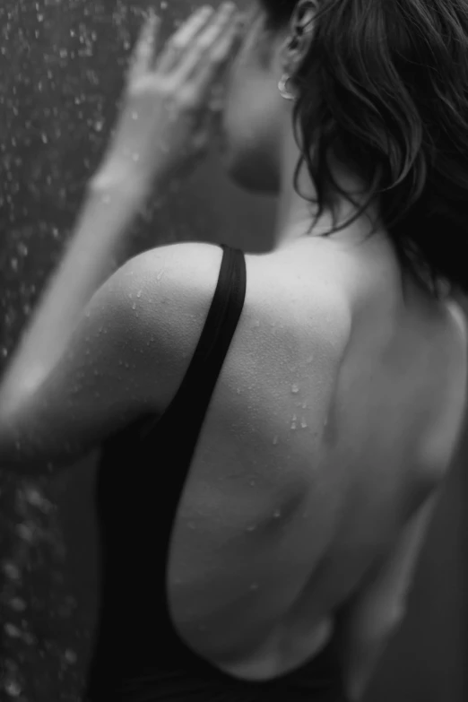 a woman taking a shower in a black and white photo, a black and white photo, by Felix-Kelly, focus her back, deviantart artstation cgscosiety, фото девушка курит, made out of rain