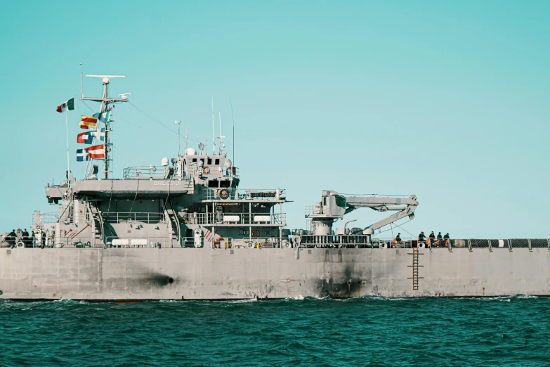 a large boat floating on top of a body of water, military equipment, on the ocean