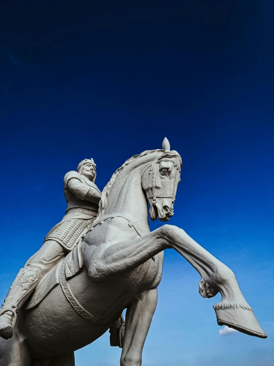 a statue of a man riding on the back of a horse, a statue, inspired by Xuande Emperor, unsplash, blue sky, square, high resolution image, kneeling