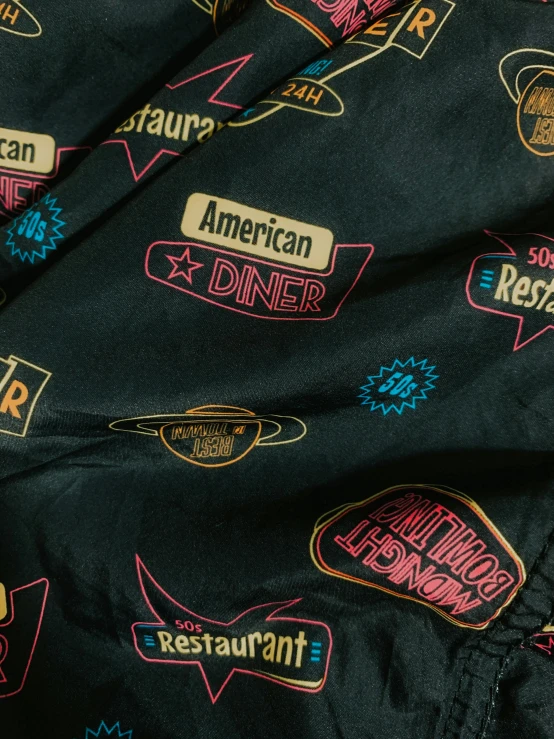 a close up of a jacket with stickers on it, international typographic style, diner scene, icon pattern, 1990s photograph, amy sol in the style of