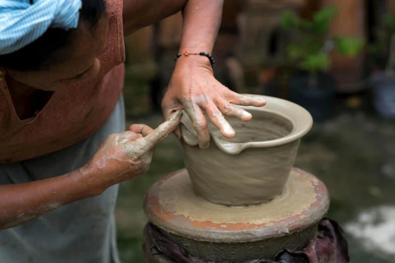 a woman is making a pot out of clay, a portrait, inspired by Hendrik Gerritsz Pot, pexels contest winner, avatar image, exterior shot, thumbnail, natural hands and arms