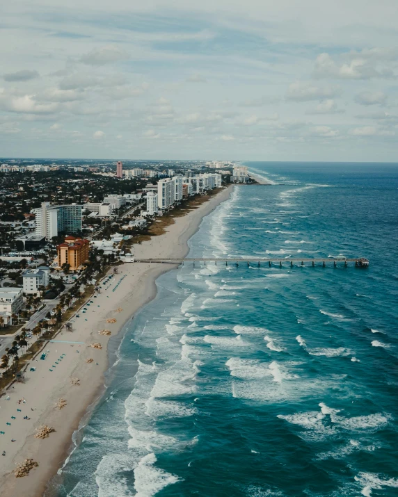 a large body of water next to a beach, by Robbie Trevino, pexels contest winner, renaissance, vice city, lgbtq, wide high angle view, zoomed out