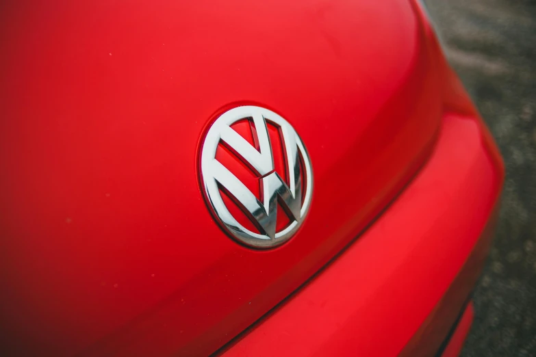 a close up of a vw emblem on a red car, unsplash, instagram picture, shot on sony a 7, 15081959 21121991 01012000 4k, micro detail 4k