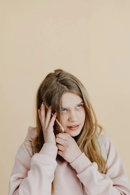 a young girl talking on a cell phone, by Attila Meszlenyi, trending on pexels, on a pale background, kid named finger, frown fashion model, tinnitus