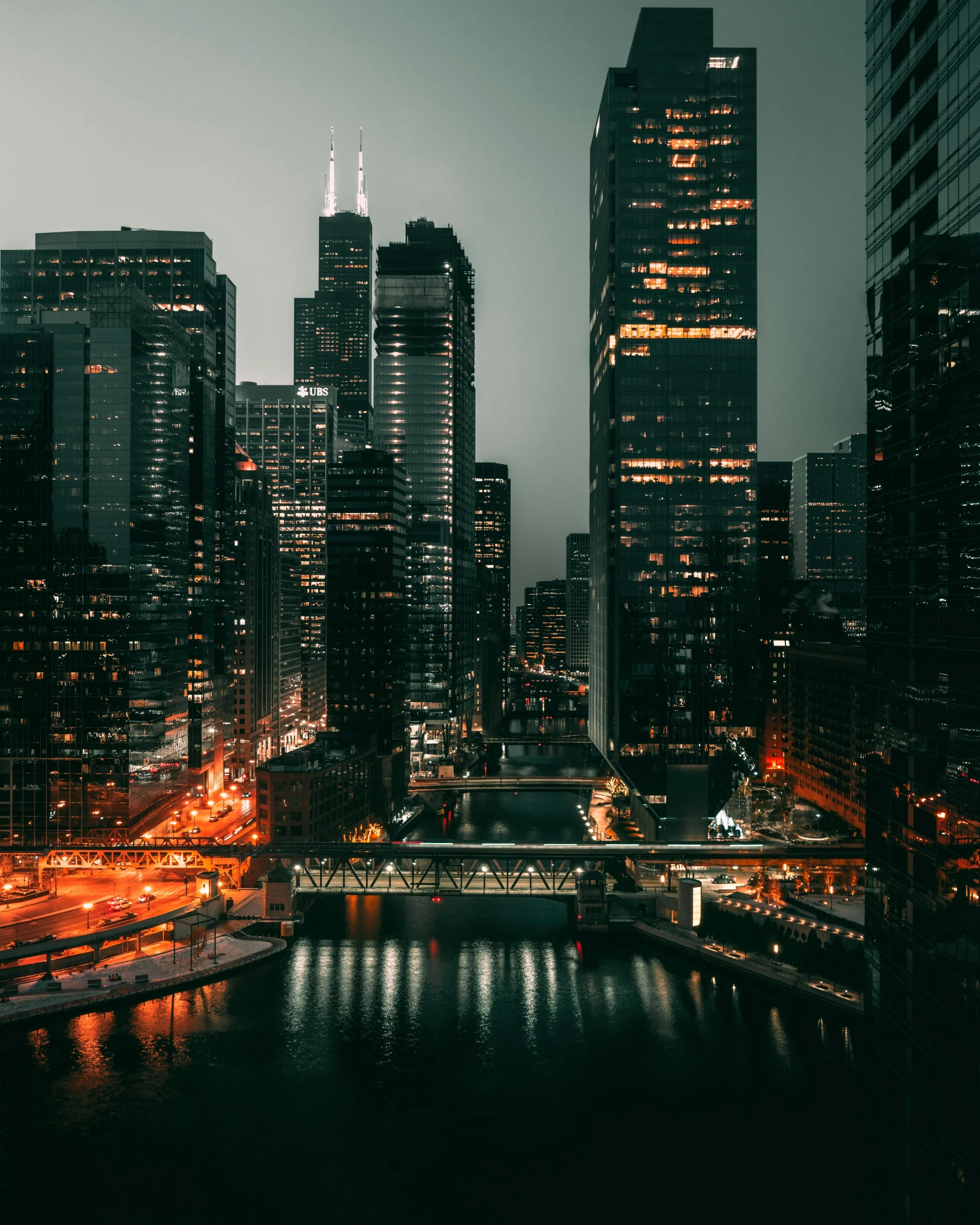 a black and white photo of a city at night, pexels contest winner, chicago, colorful city, trending on vsco, skyscrapers with greenery