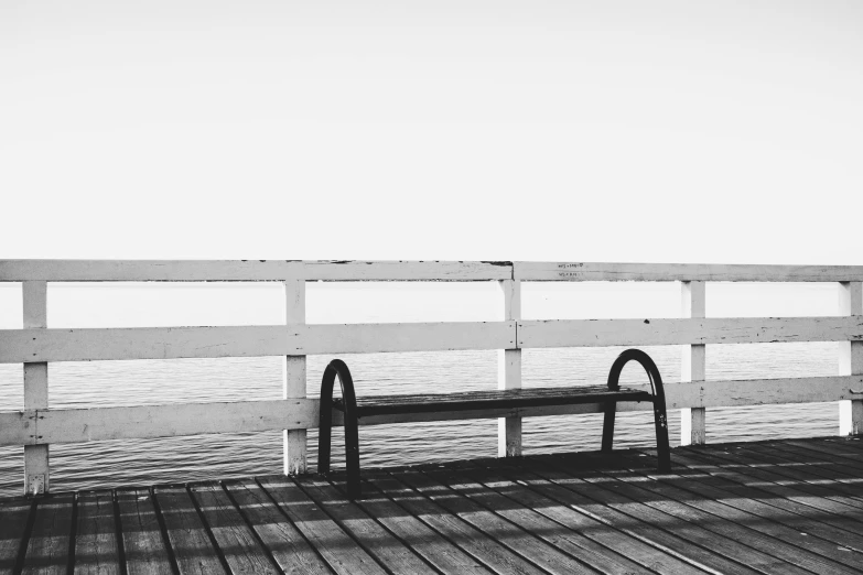 a black and white photo of a bench on a pier, a black and white photo, unsplash, postminimalism, low quality footage, instagram photo, horizon forbideen west, a wooden