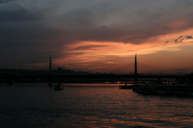 a sunset over a body of water with a bridge in the background, pexels contest winner, hurufiyya, fallout style istanbul, visible sky and humid atmosphere, olafur eliasson, brown