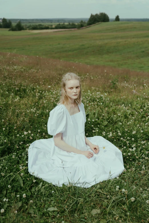 a woman in a white dress sitting in a field, pexels contest winner, renaissance, elle fanning), aurora aksnes, kirsi salonen, on a green hill