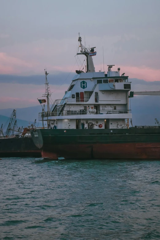 a large boat sitting on top of a body of water, happening, black sea, in the evening, trading depots, uncropped