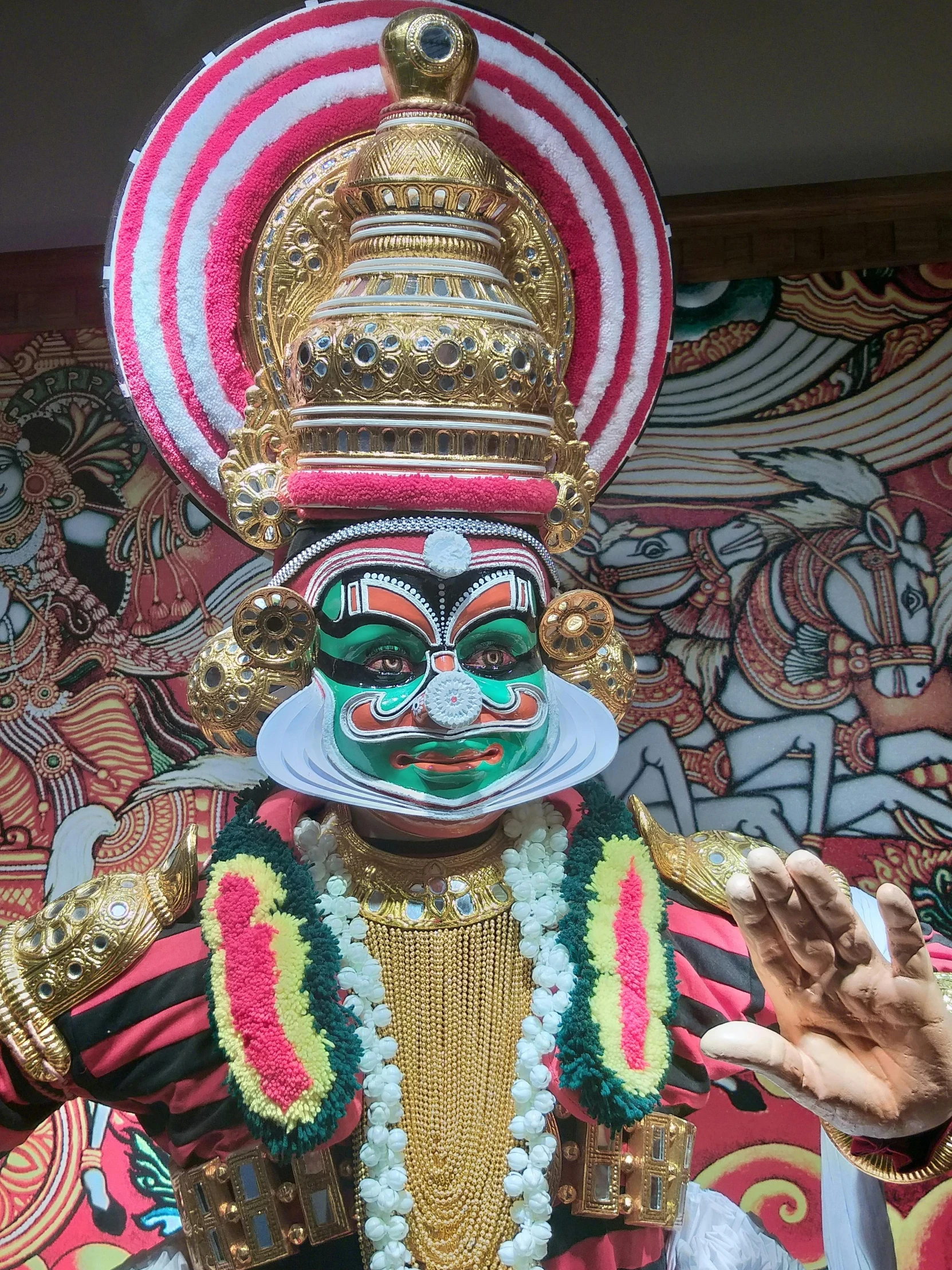 a close up of a statue of a person, a statue, with kerala motifs, white man with black fabric mask, multicoloured, image