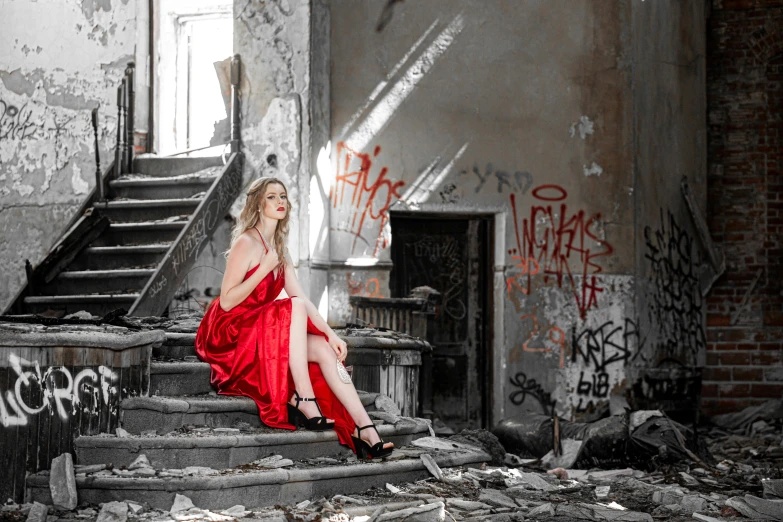 a woman in a red dress sitting on a set of stairs, by Lucia Peka, pexels contest winner, graffiti, ruined, glamour shot, demolition, profile image