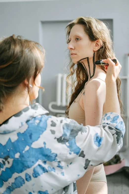 a woman standing in front of a mirror brushing her hair, by Adam Marczyński, trending on pexels, renaissance, thin bodysuit, with a stethoscope, fullbody painting, gif