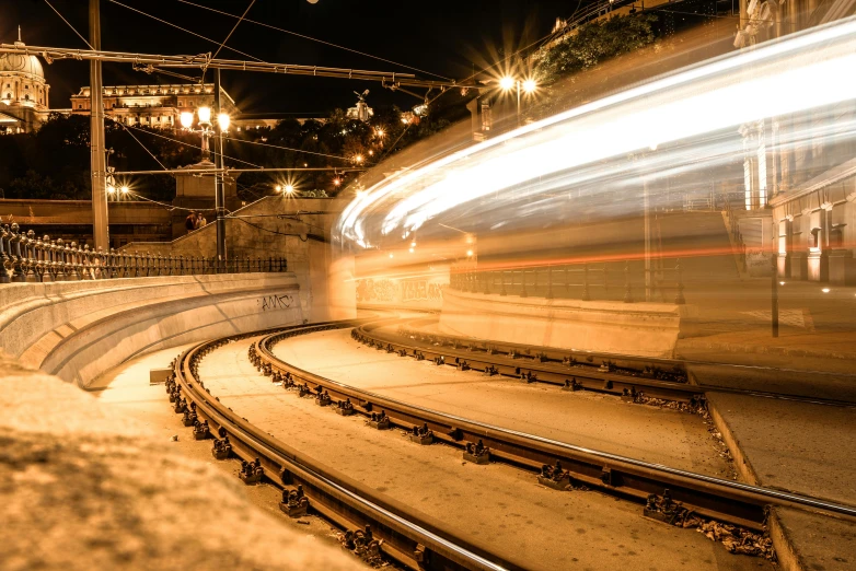 a train traveling past a train station at night, a picture, unsplash contest winner, jerusalem, tunnels, curved, thumbnail