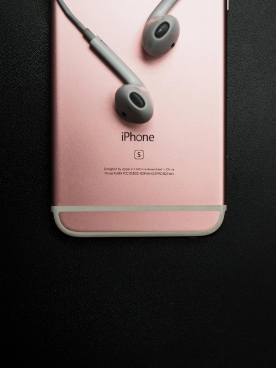 a pair of headphones sitting on top of an iphone, poster art, by Niko Henrichon, trending on pexels, hyperrealism, rose gold, silicone skin, adafruit, acronym