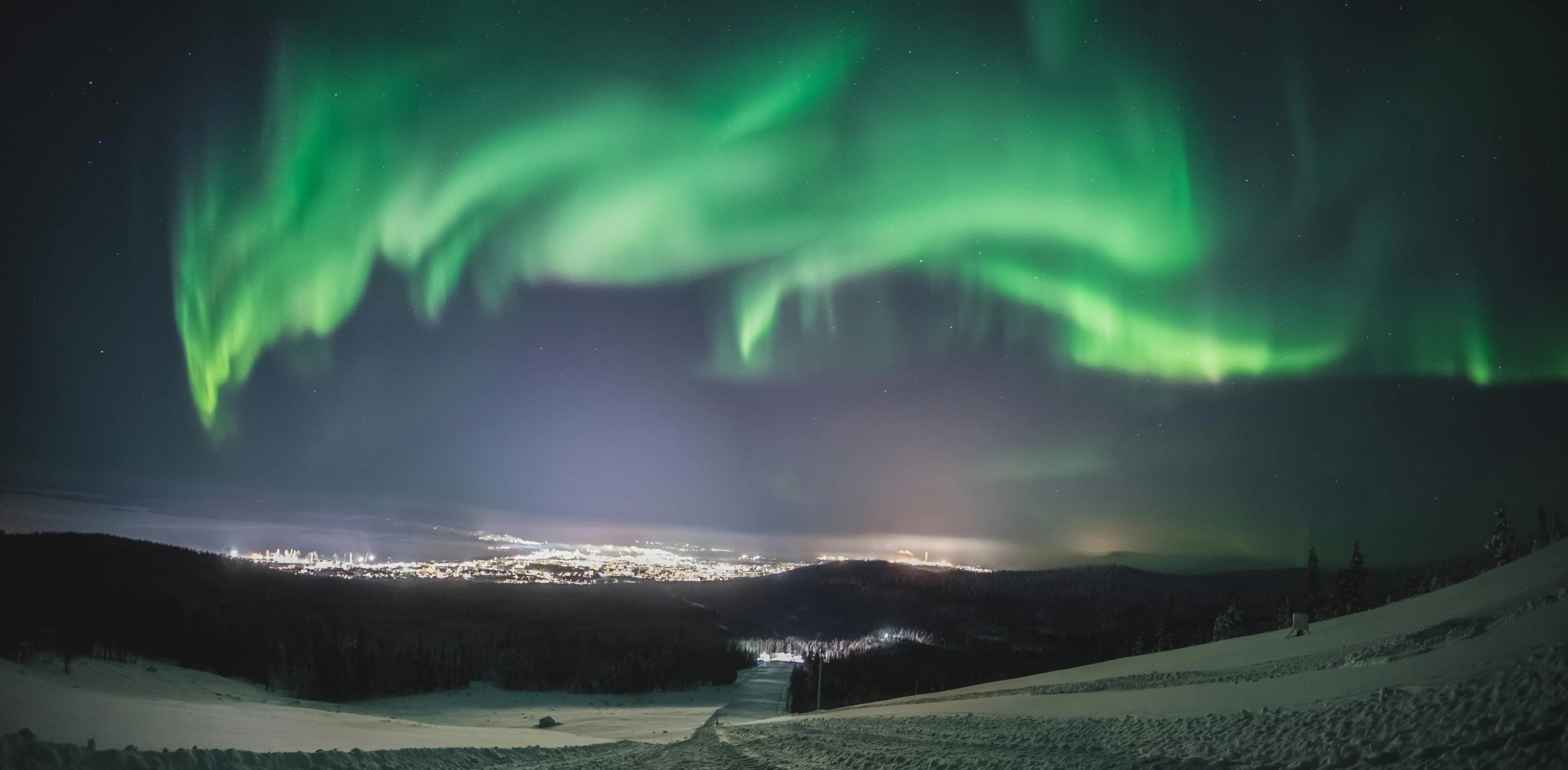 a view of the northern lights from the top of a mountain, pexels contest winner, hurufiyya, eero aarnio, grey, ultrawide lens”, distant town lights