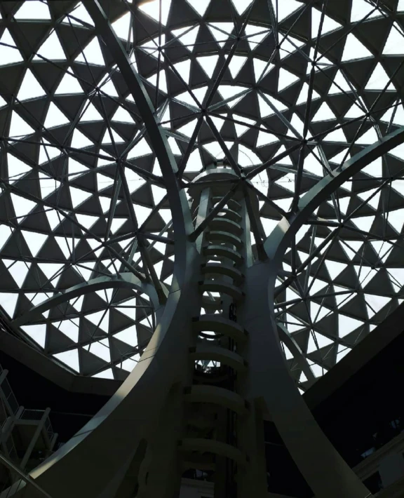 a picture of the inside of a building, inspired by Buckminster Fuller, auckland sky tower, lattice, big monocular, stands at the top