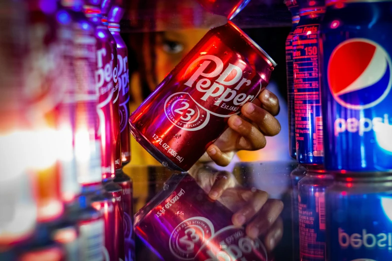 a close up of a person holding a can of pepsi, pexels, hyperrealism, lit from below with red lighting, inside a bar, silver red, pepper