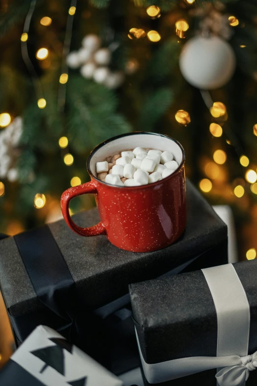 a cup of hot chocolate with marshmallows in front of a christmas tree, a portrait, by Julia Pishtar, pexels, hudson river school, made of glazed, zoomed out shot, multiple stories, detailed product shot