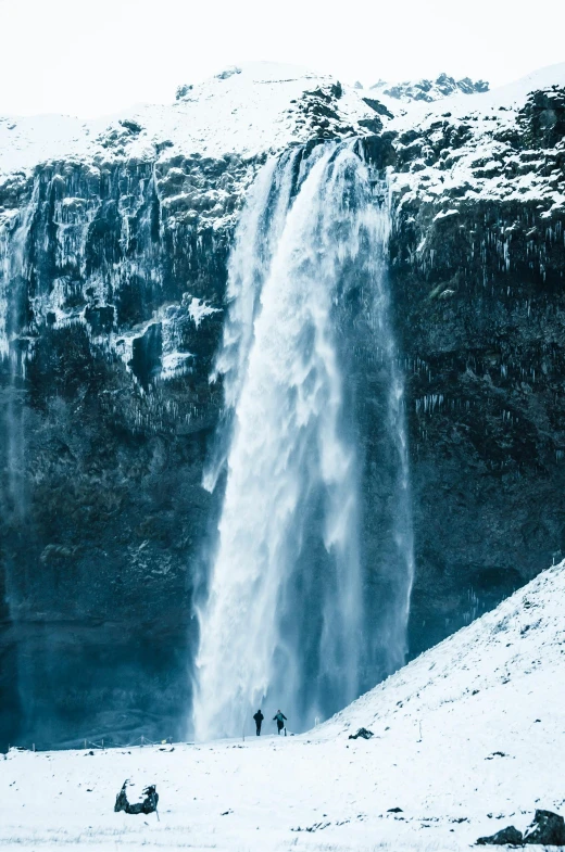 a group of people standing in front of a waterfall, a tilt shift photo, by Hallsteinn Sigurðsson, renaissance, frozen tear, whale fall, cascadia, on an icy throne