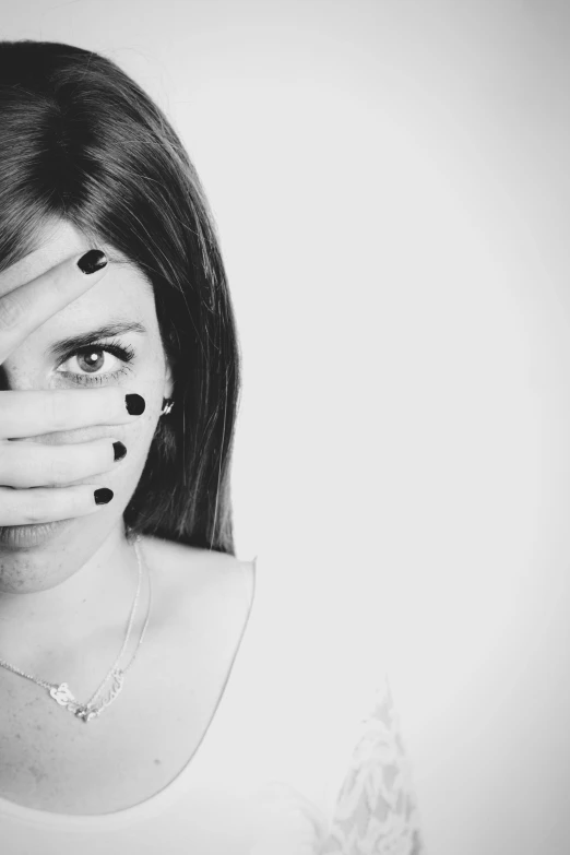 a woman covering her face with her hands, a black and white photo, trending photo, blank stare”, partially masked, with the face of emma watson