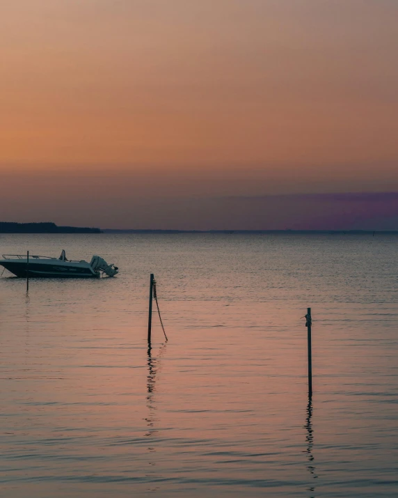 a boat floating on top of a body of water, by Jan Tengnagel, pexels contest winner, romanticism, summer evening, in muted colours, low quality photo, seaview