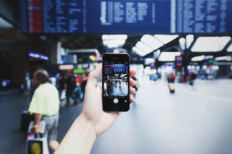 a person taking a picture of an airport, by Carey Morris, pexels contest winner, train station background, square, everything fits on the screen, waiting to strike