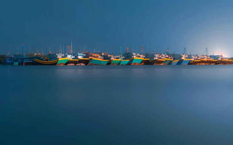 a group of boats sitting on top of a body of water, by Ibrahim Kodra, pexels contest winner, minimalism, night colors, shipping docks, profile pic, jakarta