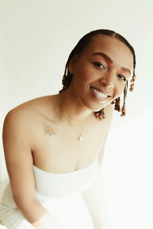 a woman in a white dress sitting on a bed, by Dulah Marie Evans, trending on pexels, antipodeans, smiling fashion model face, wiz khalifa, ashteroth, headshot profile picture