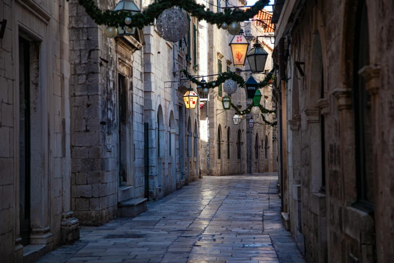 a narrow street in an old european city, by Matija Jama, pexels contest winner, baroque, square, holiday, [ cinematic, decorations