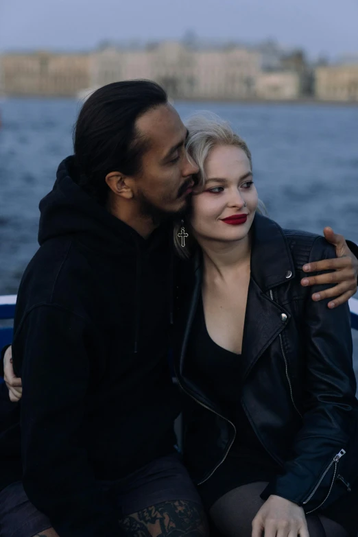 a man and woman sitting next to each other on a boat, a photo, by Jaakko Mattila, mixed race, profile image, frank dillane, hugging each other
