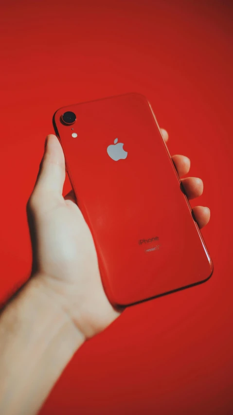 a person holding a red iphone in their hand, by Robbie Trevino, pexels, square, ap press photo, 2263539546], 🚀🌈🤩