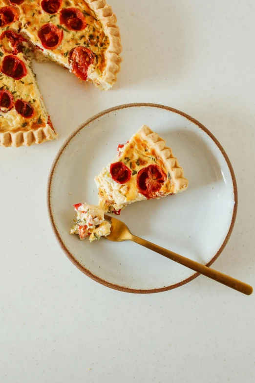 a white plate topped with a slice of pizza, by Winona Nelson, red and golden color details, spoon placed, midsommar - t, cream