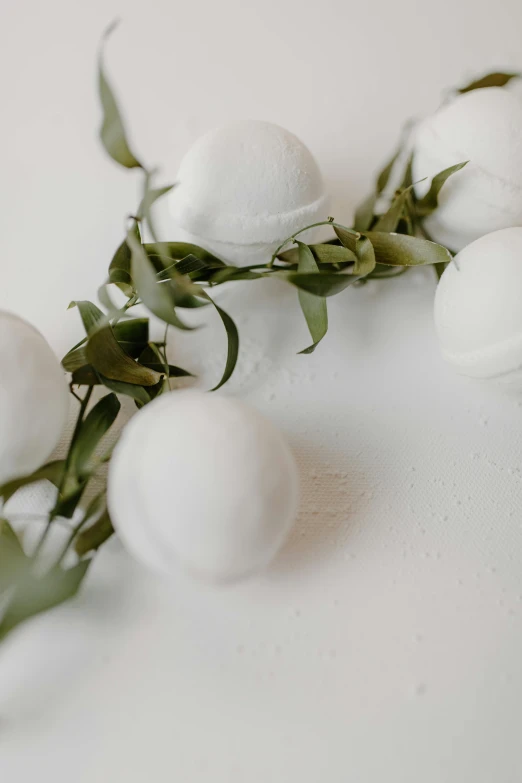 a bunch of white balls sitting on top of a table, white flower crown, detailed product image, detail shot, white neon wash