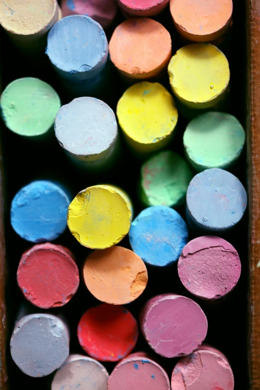 a wooden box filled with different colored chalks, chalk art, crayon art, up-close, taken in the late 2000s, color”