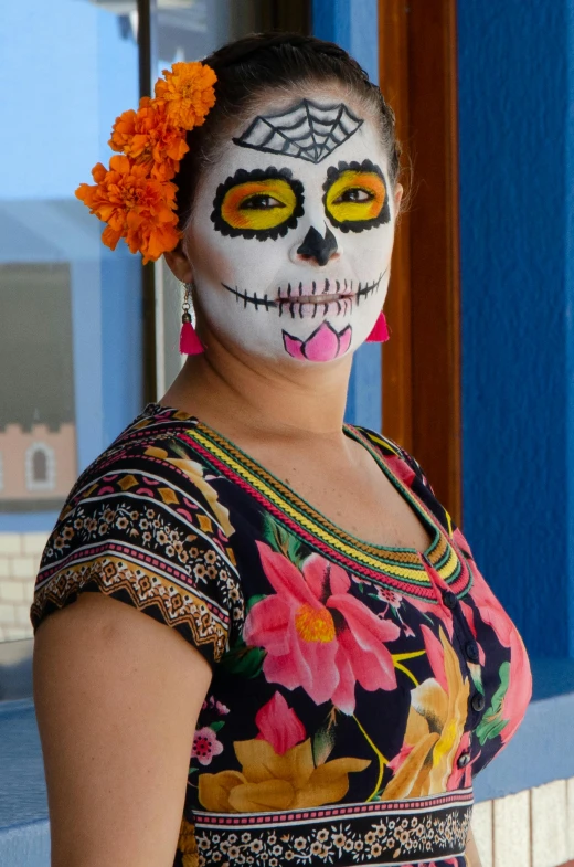 a woman with a flower in her hair, inspired by Frida Kahlo, skull face paint, guanajuato, slide show, on a bright day