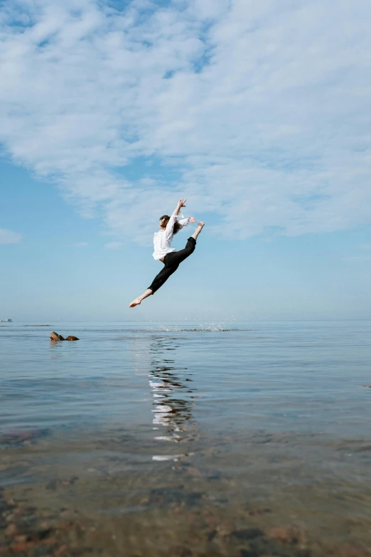 a man jumping in the air over a body of water, by Nina Hamnett, arabesque, highly upvoted, oceanside, high-quality photo, emily rajtkowski