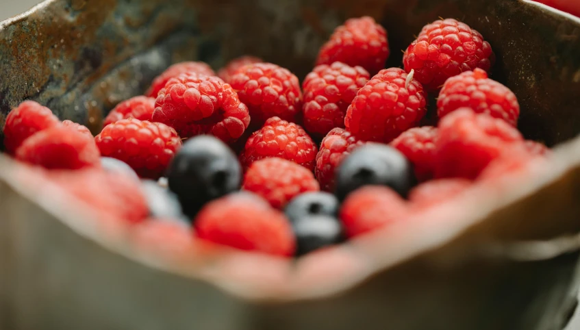 a metal bowl filled with raspberries and blueberries, by Adam Marczyński, pexels, black and red colour palette, 🦩🪐🐞👩🏻🦳, bowl filled with food, avatar image