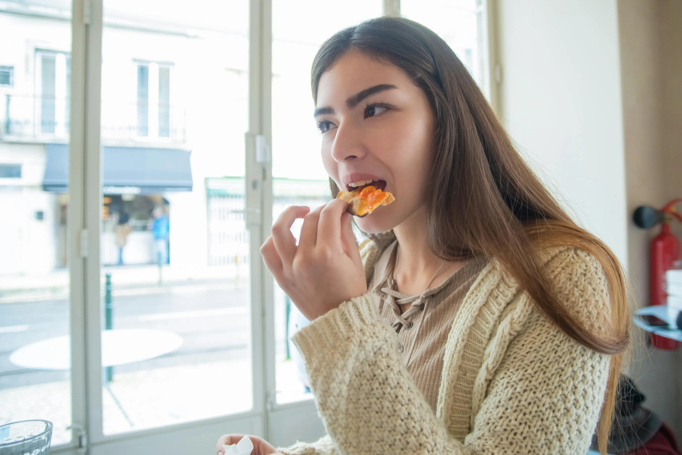 a woman sitting at a table eating a piece of pizza, trending on pexels, eating mars bar candy, eating garlic bread, profile image, pointè pose