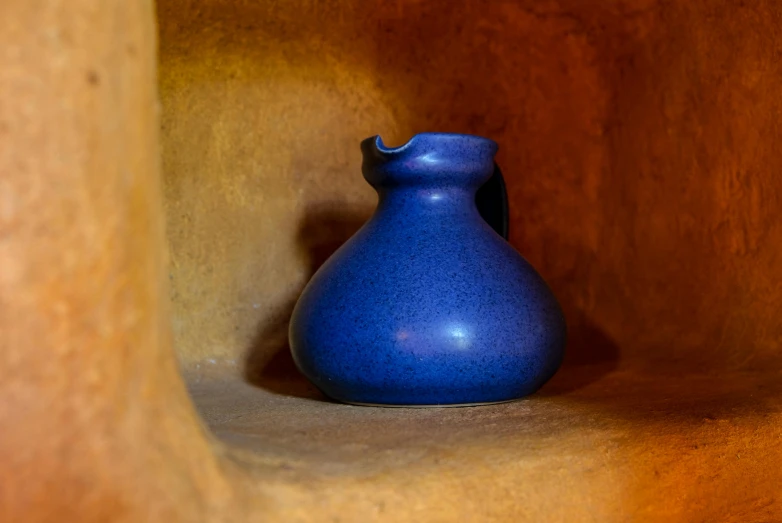 a blue vase sitting on top of a wooden shelf, inspired by Juan O'Gorman, pexels contest winner, mingei, found in a cave made of clay, thumbnail, chile, water pipe