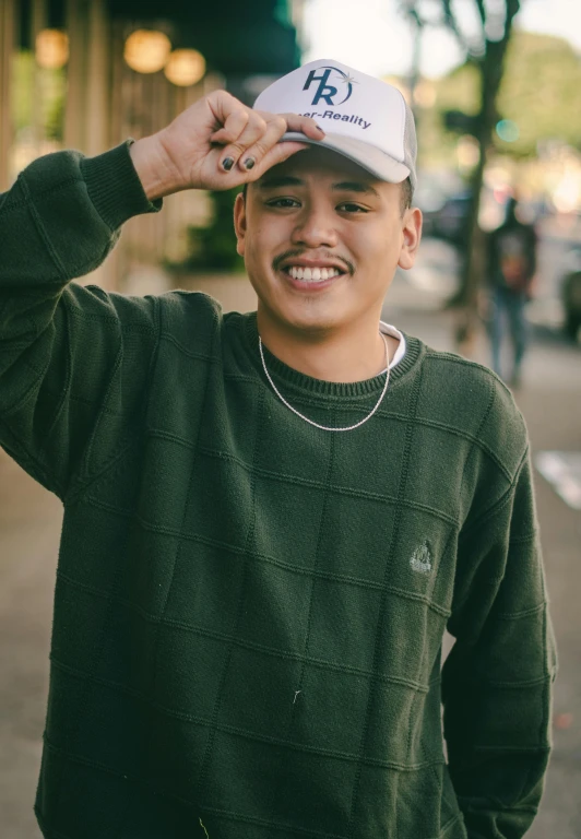 a man in a green sweater and a white hat, inspired by Eddie Mendoza, unsplash, realism, friendly smile, bladee from drain gang, smol, waist high