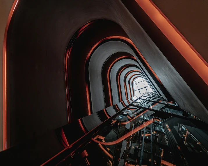 a staircase going up to the top of a building, by Adam Marczyński, unsplash contest winner, art nouveau, black and orange, inside a spaceship, multiple stories, black and red tones