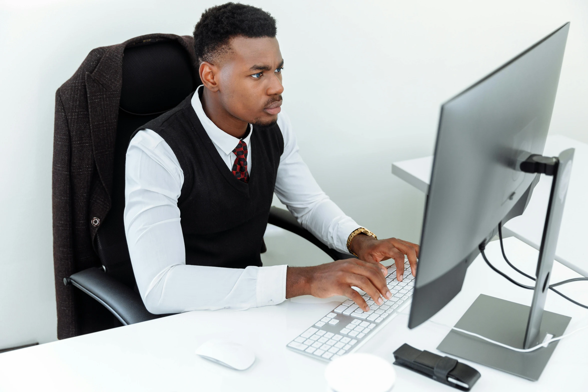 a man sitting at a desk using a computer, trending on pexels, osborne macharia, formal attire, avatar image, black people